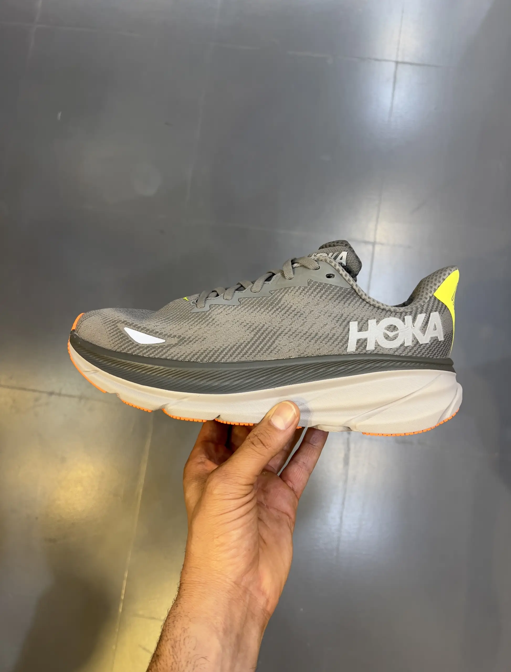 hoka-clifton-9-asphalt-grey-gravel-1141470f-altg-hand-view hoka clifton 9 asphalt grey gravel 1141470f altg hand view